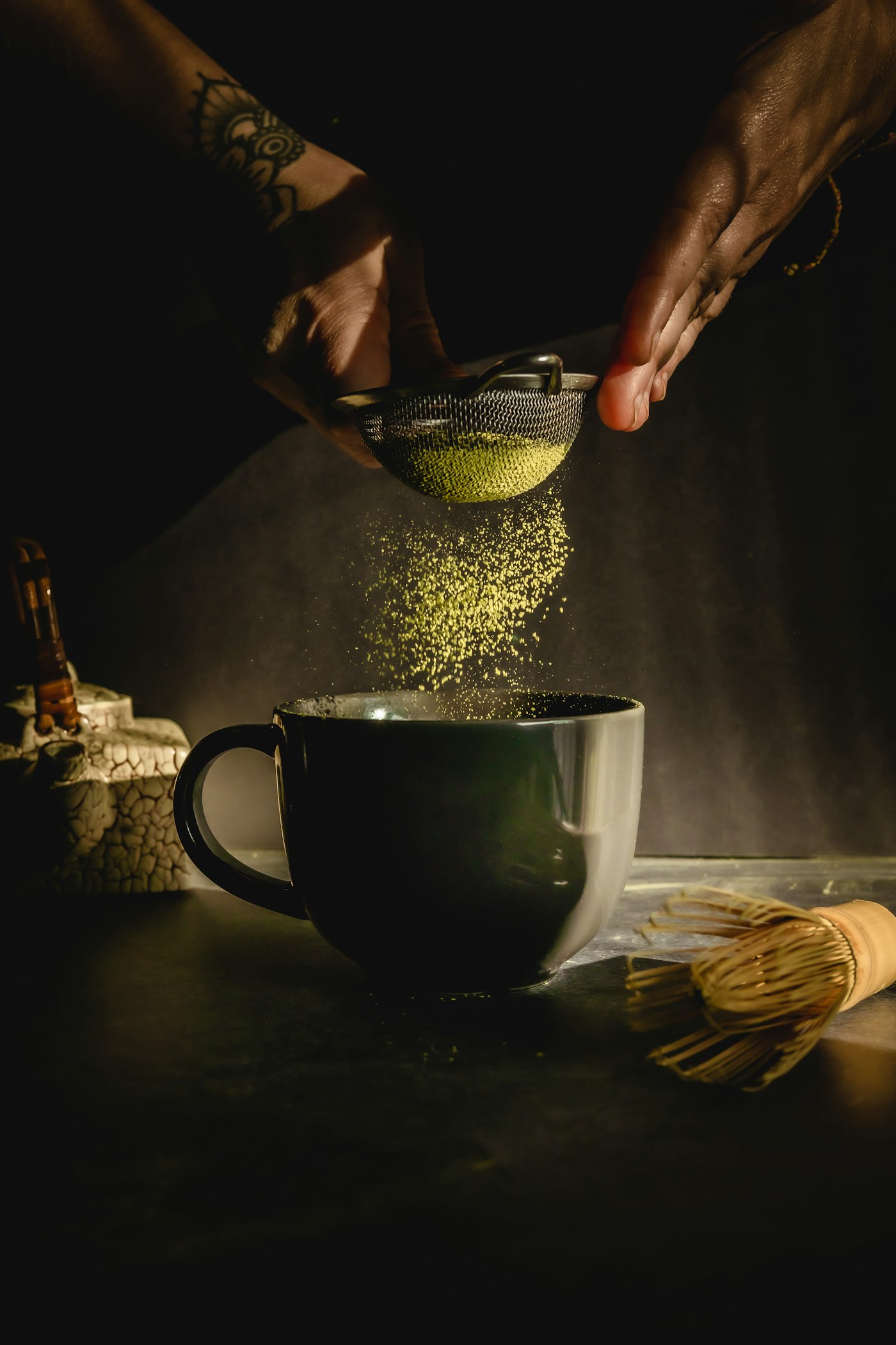 Matcha powder being poured into a tin