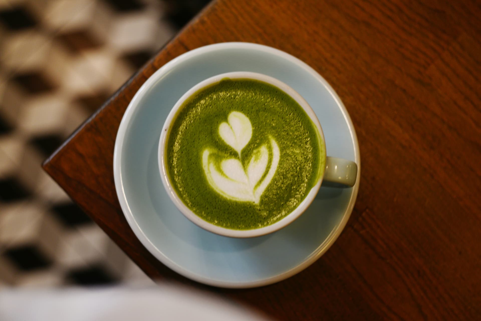 Matcha latte with latte art in a ceramic cup